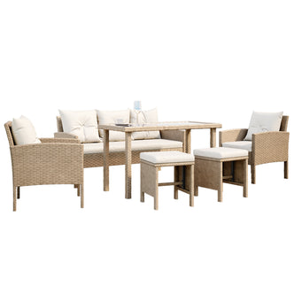 Vero 7 Seater Wicker Outdoor Sofa Dining Set, highlighting the intricate wicker design on the chair armrest, plush pillow, and sturdy footstool for a cozy outdoor setup.