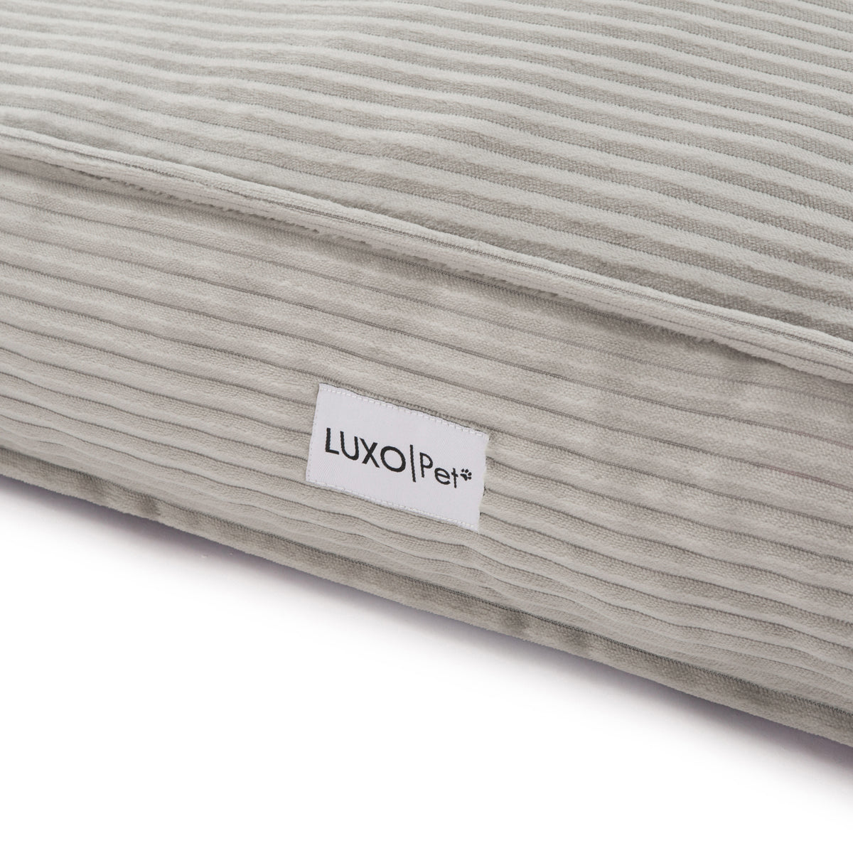 Close-up of the Dax Medium Corduroy Dog Bed – Grey Soft Support, showcasing its plush fibre filling, raised bolstered edges, and corduroy texture for pet comfort and modern home style.
