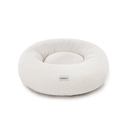 Kyra Medium Boucle Pet Bed – Light Beige Comfort, features soft, raised bolsters and plush boucle fabric, designed for ergonomic pet support and modern style, with a smooth, non-slip base.