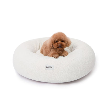 Kyra Medium Boucle Pet Bed – Light Beige Comfort: Close-up of a plush dog bed with soft, raised bolsters and a boucle texture, designed for ergonomic pet support and fitting modern interiors.