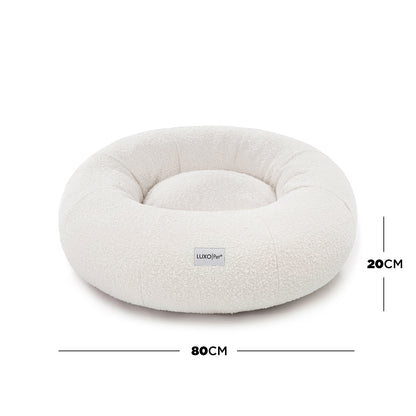 Kyra Medium Boucle Pet Bed – Light Beige Comfort featuring supportive raised bolsters and plush boucle fabric for ergonomic pet lounging. Designed for elegance and stability with a non-slip base.