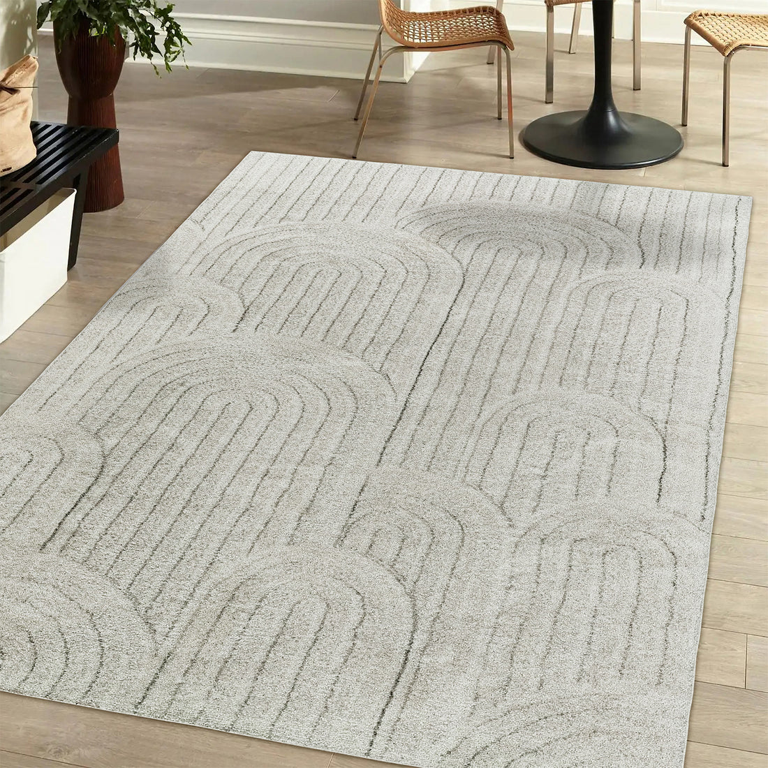 A close-up of the Aetherine Soft Contemporary Rug 200x300cm, showcasing its plush 12mm pile and modern printed design, placed on a hardwood floor, partially under a chair and near a potted plant.