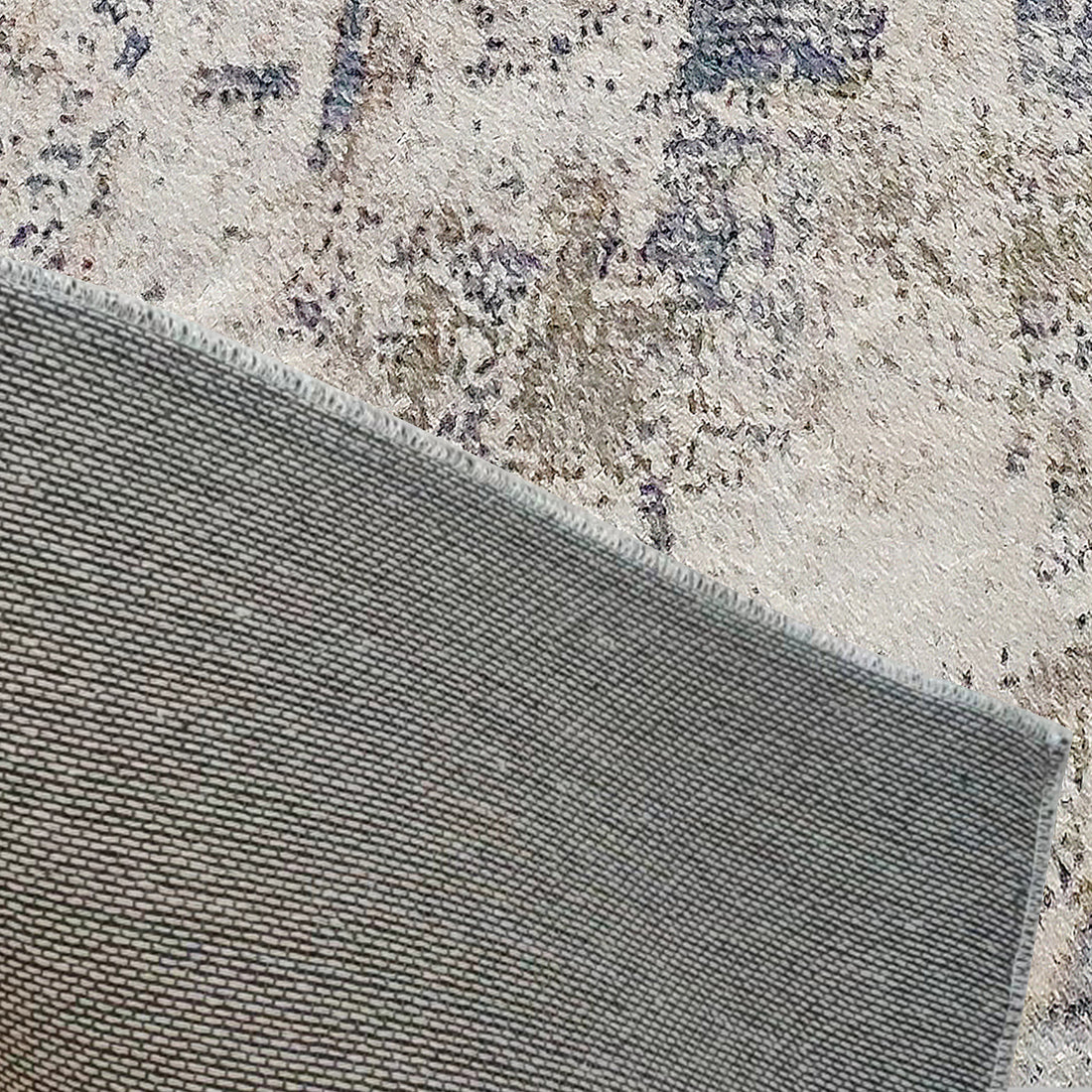 Close-up of the Ari Abstract Tufted Polyester Rug 200x300cm, showing the grey woven backing and decorative patterned pile, highlighting its modern abstract design and plush texture.