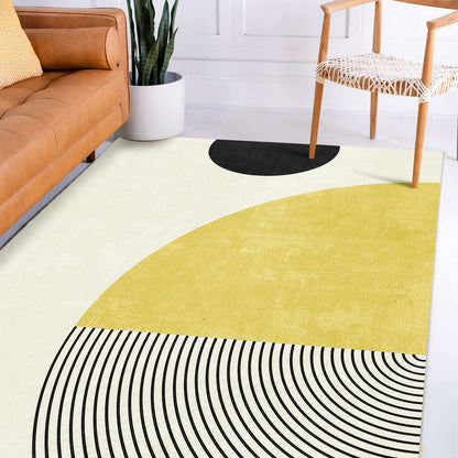 Axland Modern Abstract Floor Rug 200 x 300cm lies on the floor, featuring a light cream, mustard yellow, and black pattern, enhancing the minimalist space with its bold geometric shapes.