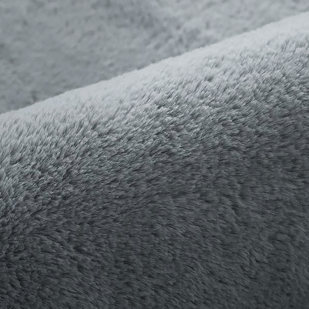 Close-up of Azaliya Dark Grey Faux Rabbit Fur Rug 200x300cm, showcasing its plush, fuzzy texture resembling soft fleece, ideal for adding luxurious comfort to modern or minimalist interiors.