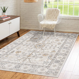 Bortan 200x300cm Large Persian Indoor Floor Rug with a vintage pattern on a wood floor, complemented by a white accent chair, cream throw, and mid-century modern sideboard in a sunlit room.