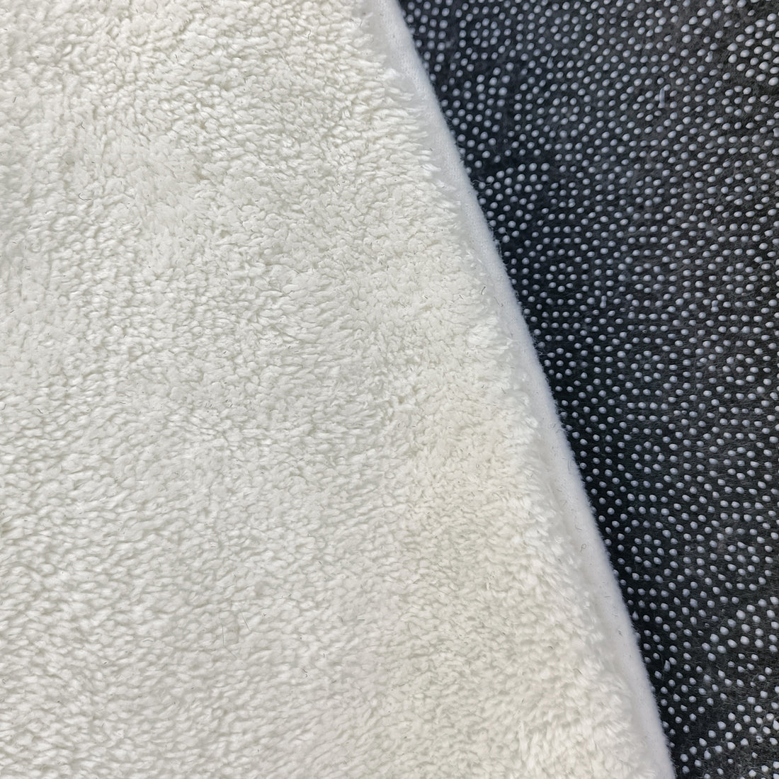 Callista 160cm Kids Round Colourful Spot Indoor Floor Rug shown with a plush, cream white terry-cloth texture atop a black, non-slip mat, highlighting its soft, inviting surface.