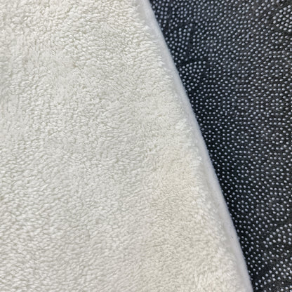 Callista 160cm Kids Round Colourful Spot Indoor Floor Rug shown with a plush, cream white terry-cloth texture atop a black, non-slip mat, highlighting its soft, inviting surface.