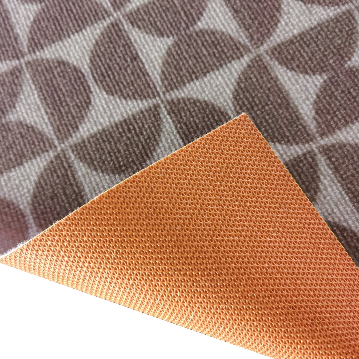 Close-up of Dolly Brown outdoor floor rug showing textured orange-brown woven underside and striped grey-brown patterned top