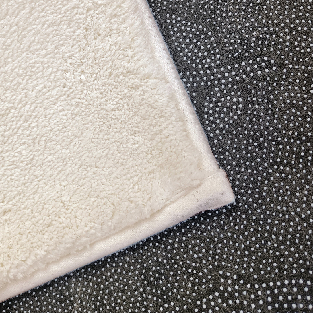 Evane 120x180cm Kids Cloud Modern Indoor Floor Rug showcasing white plush-pile fabric atop dark rubberized non-slip backing with white grip dots, designed for children's room comfort and safety.