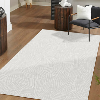 Malung 200x300cm Contemporary Indoor Floor Rug with a random stick-like line pattern, centered on a warm wood floor, complements a black lounge chair and dark-stained side table with sculpture.