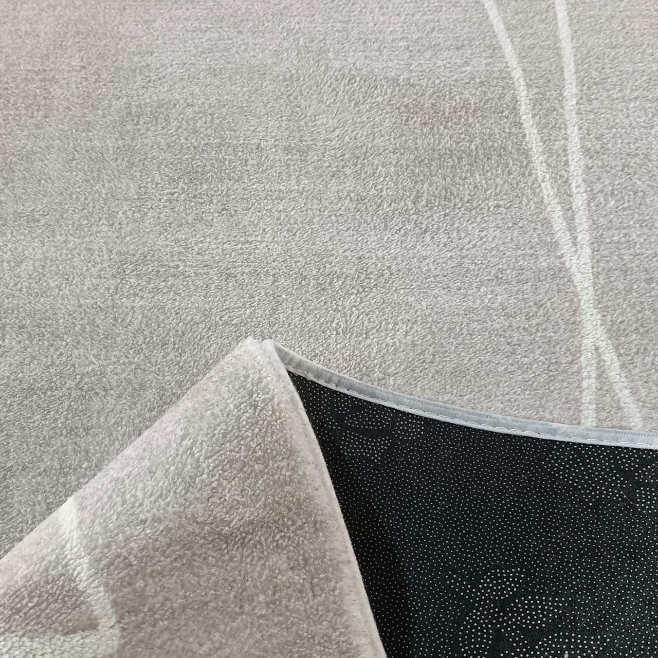 Manstad 160x230cm Modern Indoor Floor Rug, grey with low-pile texture, features one flipped corner revealing black non-slip dotted backing, showcasing its modern design and functionality.
