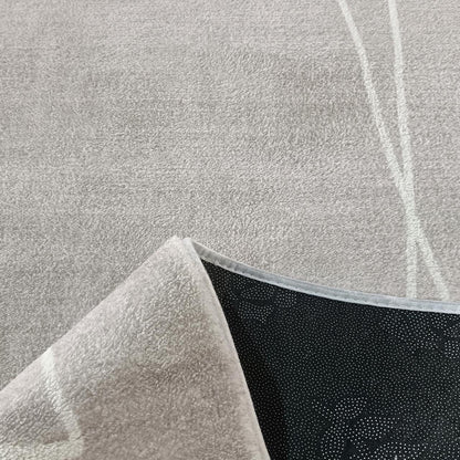 Manstad 160x230cm Modern Indoor Floor Rug, grey with low-pile texture, features one flipped corner revealing black non-slip dotted backing, showcasing its modern design and functionality.