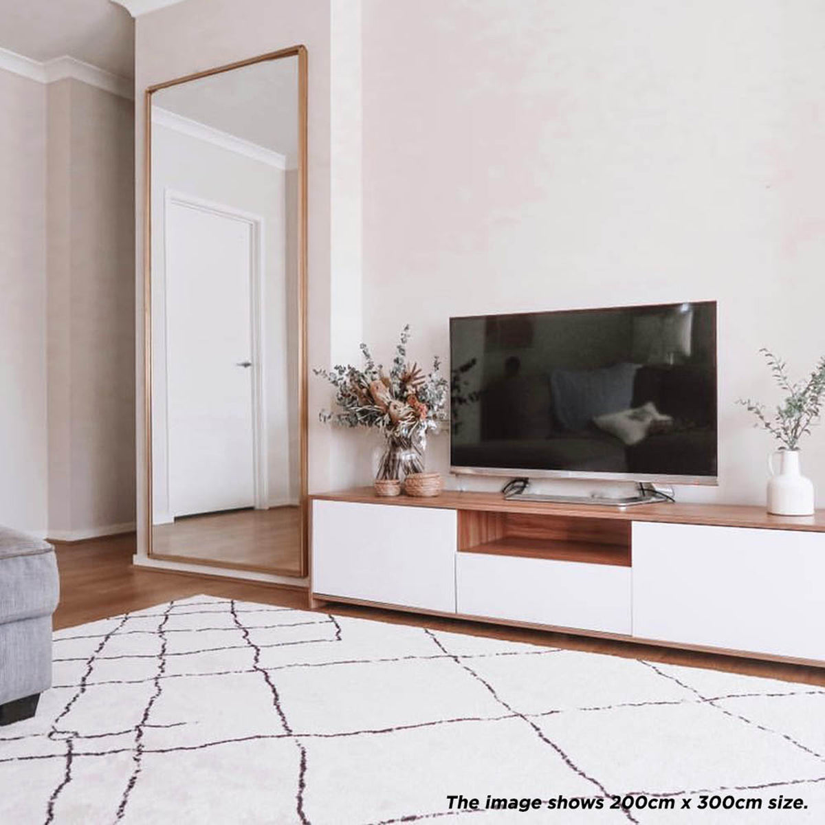 Melody Black & White Modern Rug 160x230cm displayed, featuring abstract black lines on an ivory base, ideal for enhancing dining or living areas with its Scandinavian-inspired design.