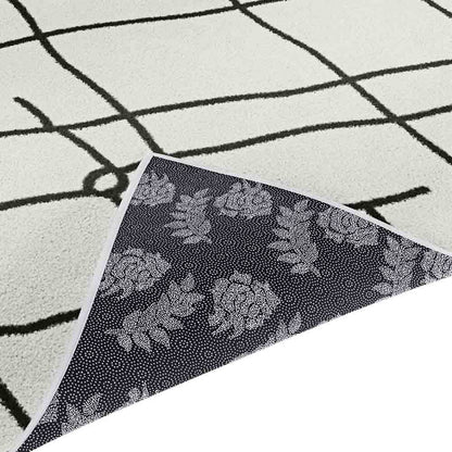 Melody Black and White Modern Floor Rug 200 x 300cm showing corner detail with black grid pattern on ivory pile and dark