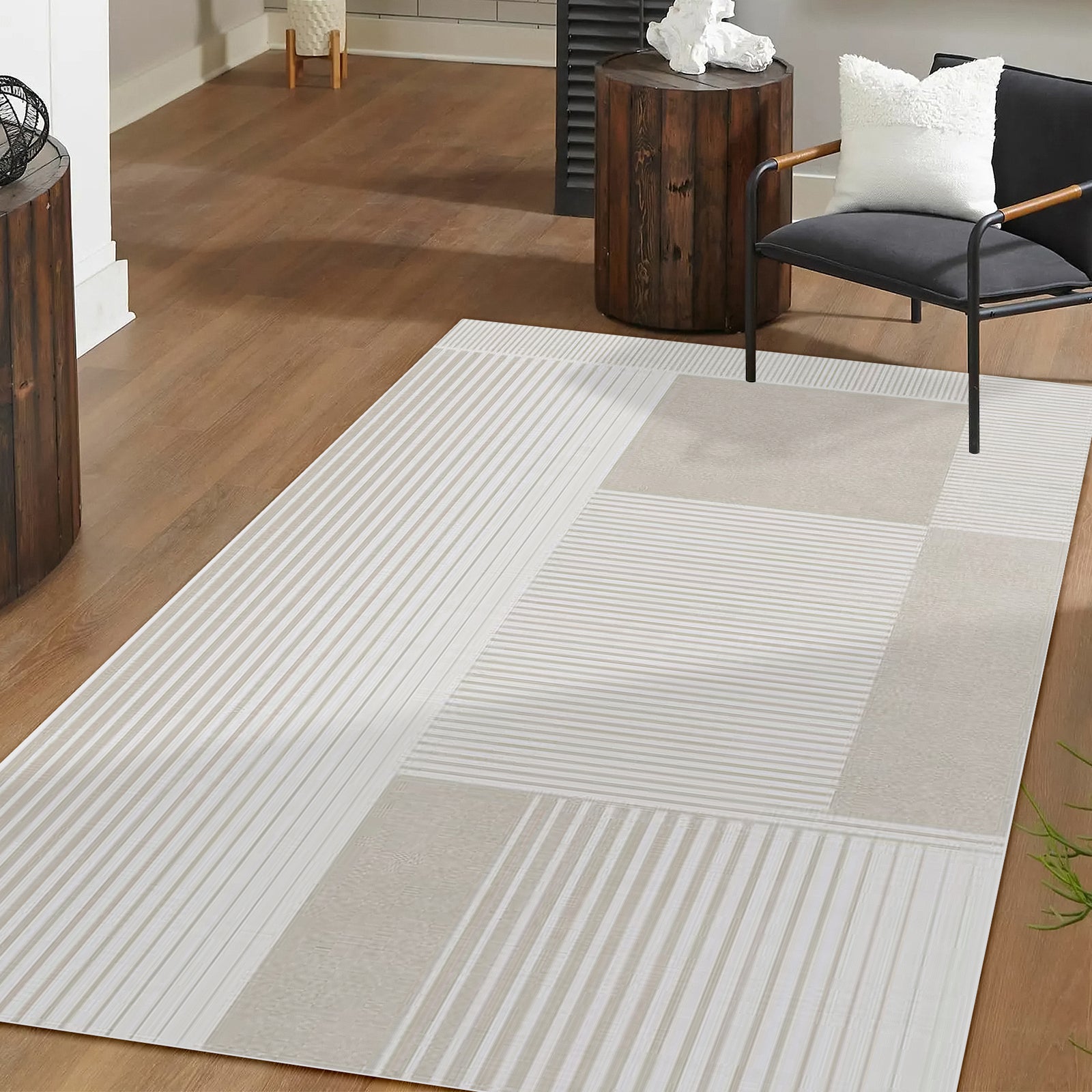 Nicho 200x300cm Polyester Tufted Modern Abstract Indoor Rug on a wood floor, featuring a block and stripe pattern, with a black lounge chair and rustic side tables in a minimalist living area.