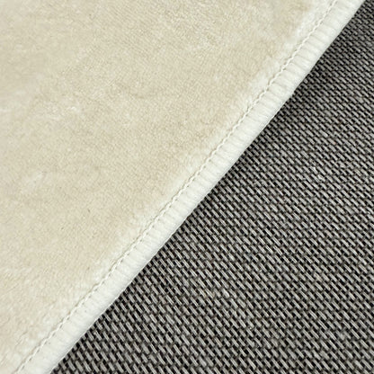 Pixie 240x330cm Wavy Large Shag Rug in Beige; close-up shows cream short-pile fabric and gray chunky woven texture, highlighting the rug's plush softness and durable design.