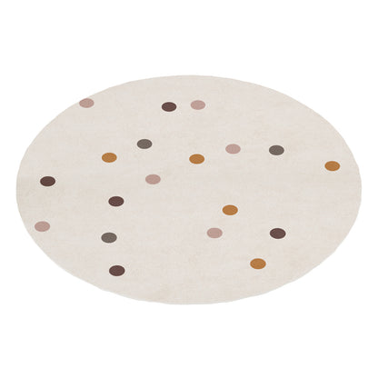 A round, cream-colored kids rug featuring a scattered pattern of multi-colored polka dots in muted tones of brown, ochre, and dusty pink.