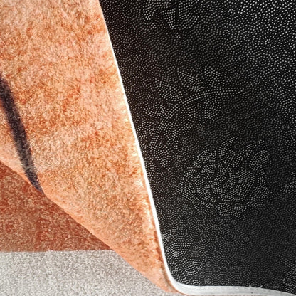 Close-up of the Skalo 160x230cm Medium Contemporary Colourful Kids Indoor Rug, showcasing plush orange fabric with non-slip black backing, highlighting the rug's texture and safety features.