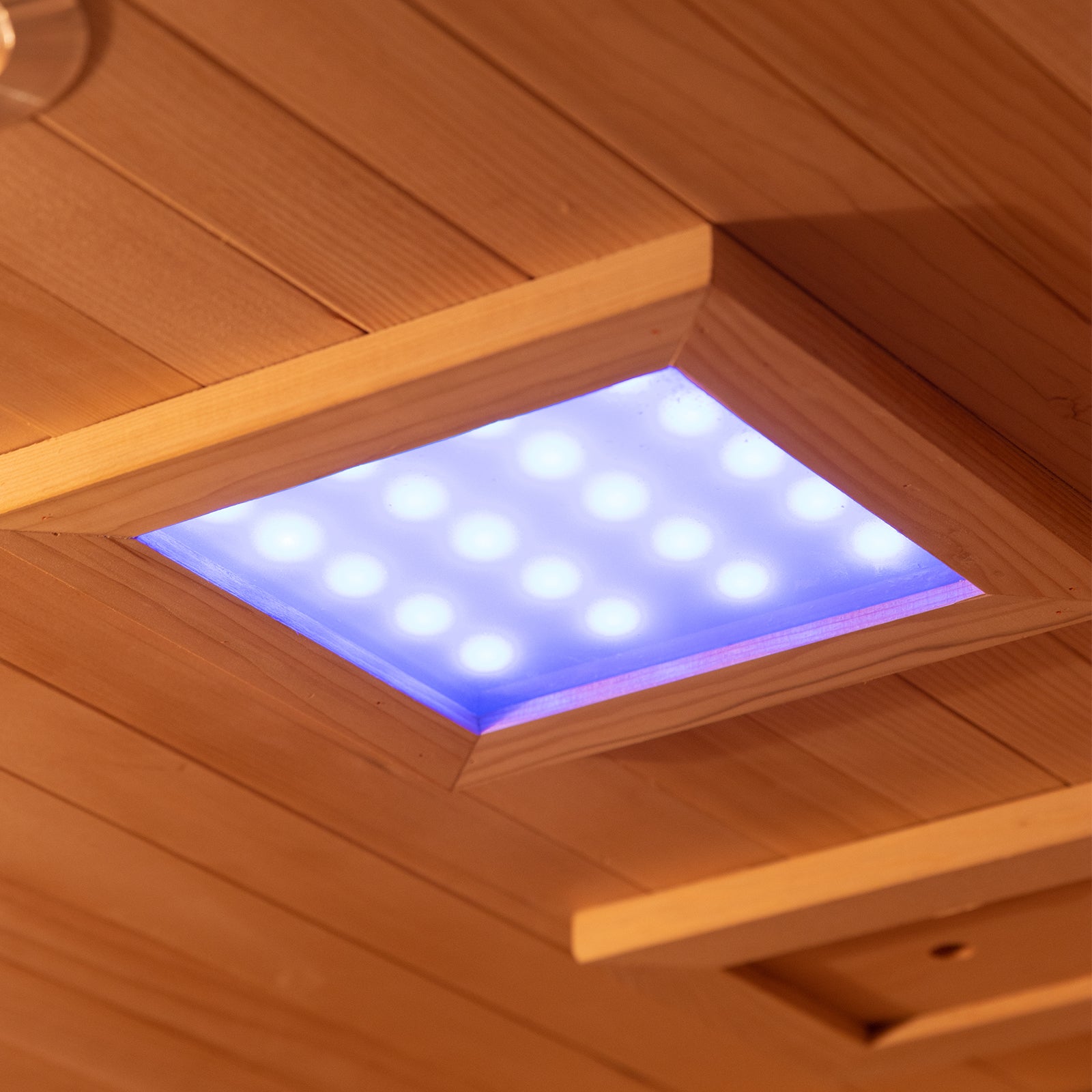 Wood-paneled ceiling with recessed LED light in Harlow 2 Person Canadian Hemlock Infrared Home Sauna, showcasing the modern, serene interior designed for a relaxing wellness experience.