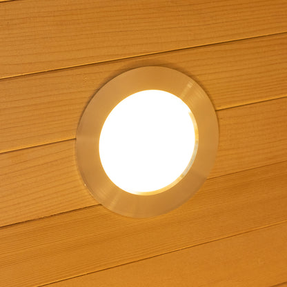 Harlow 2 Person Canadian Hemlock Infrared Home Sauna shown with a round recessed LED downlight in a wood-plank ceiling, creating a warm, inviting atmosphere for relaxation and wellness.