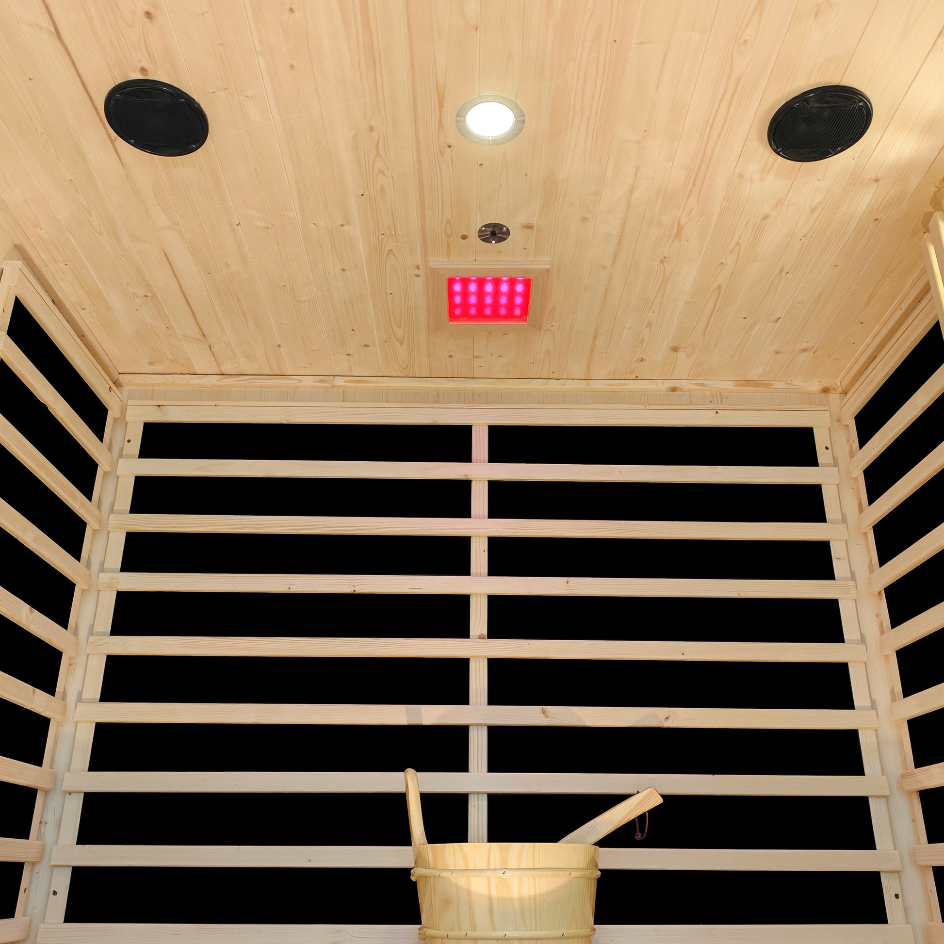 Interior ceiling of Kiima 3-Person Hybrid Sauna showing light, speakers, and red infrared panel