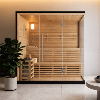 Kivi 4 Person Traditional Stove Finnish Indoor Home Sauna with glass front, wooden benches, a metal-framed heater with stones, a bucket, ladle, and a thermometer inside a minimalist spa-style setting.