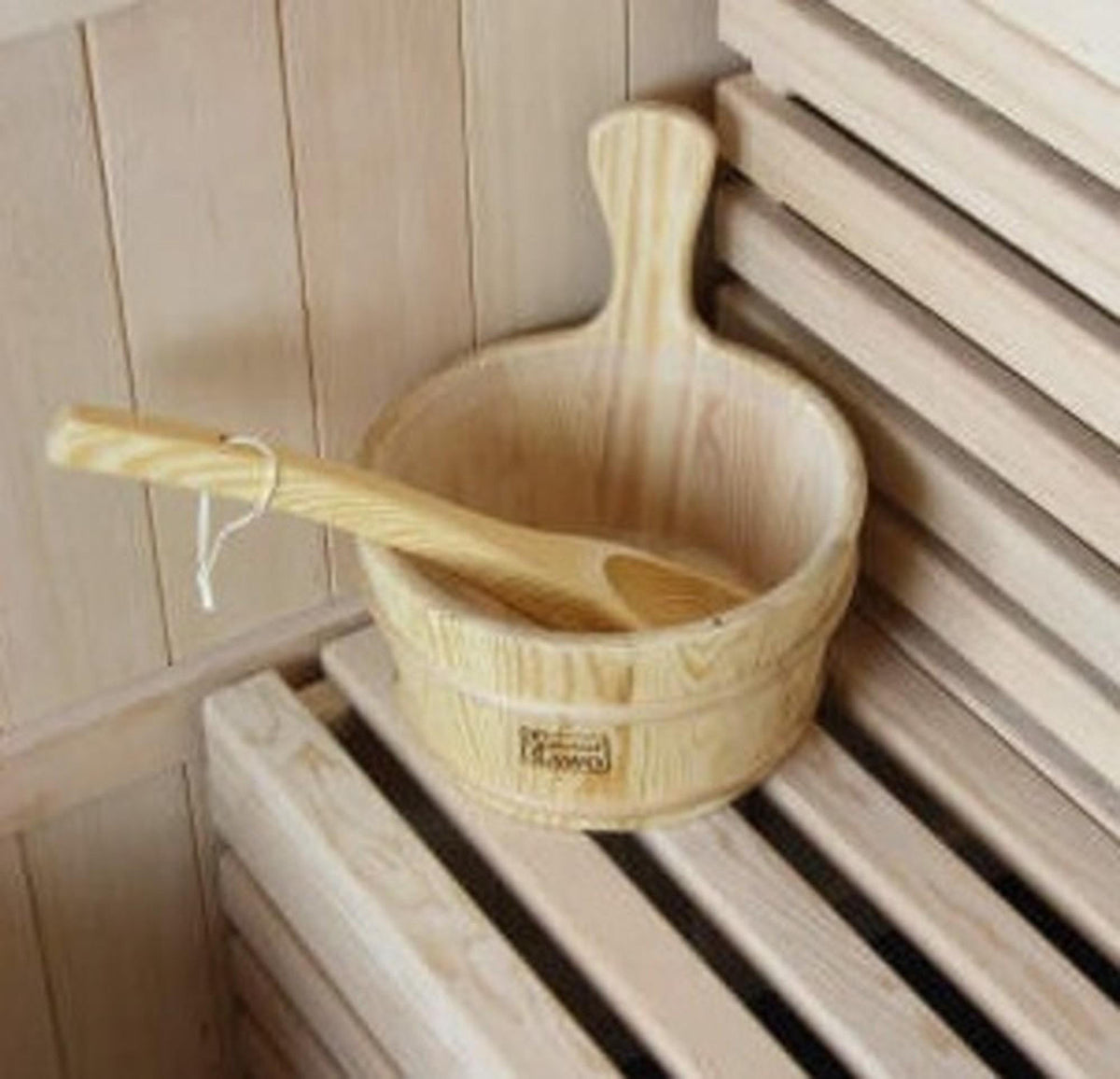 Kivi 6-Person Traditional Finnish Indoor Home Sauna set includes a wooden bucket and ladle on a slatted bench, perfect for authentic steam rituals in your personal wellness space.