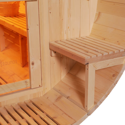 Luola 2 Person Pine Outdoor Barrel Sauna & Harvia Stove features light timber paneling, a slatted folding bench, and a wooden sauna bucket, viewed through a glass door in a cozy, barrel-style design.