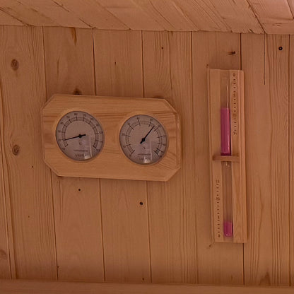 Medika 8 Person Traditional Finnish Outdoor Sauna with a close-up of a thermometer and temperature gauge, featuring durable fir wood and a tempered glass door for a calming wellness retreat.