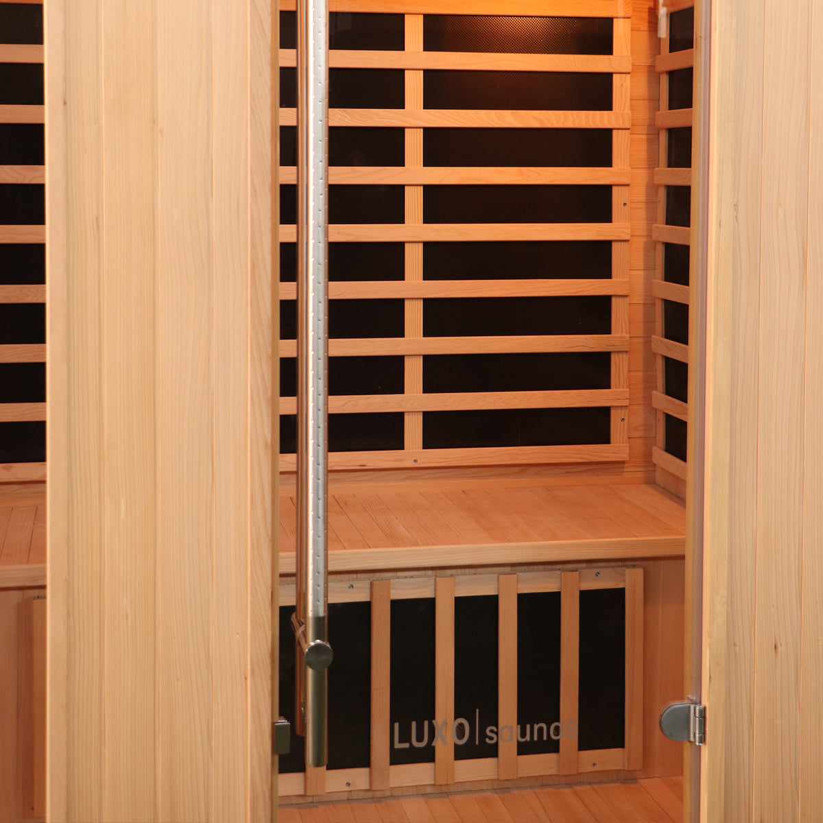 Valo 3 Person Carbon Fibre Infrared Indoor Sauna features a wooden interior with a bench, slatted backrests, infrared heater panels, and a glass door with a stainless steel handle.