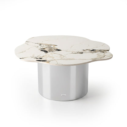 Modern coffee table with an irregular marble-look top and metallic cylindrical base on a white background