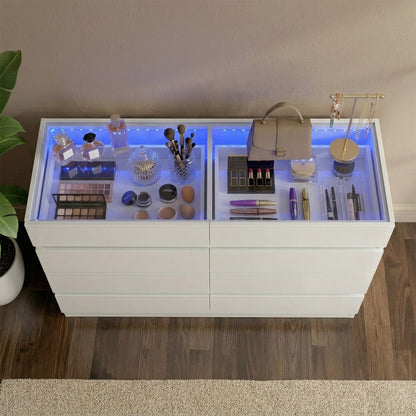 White dresser with glass top display case illuminated by blue LED lighting, showcasing cosmetics and accessories