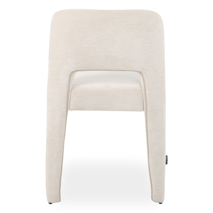Edris upholstered dining chair in oat fabric with curved backrest and cut-out detail, shown from rear view