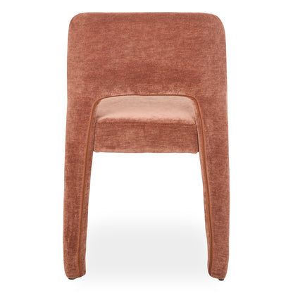 Edris upholstered dining chair in terracotta with curved backrest and seat, featuring piped edges and fabric-covered legs