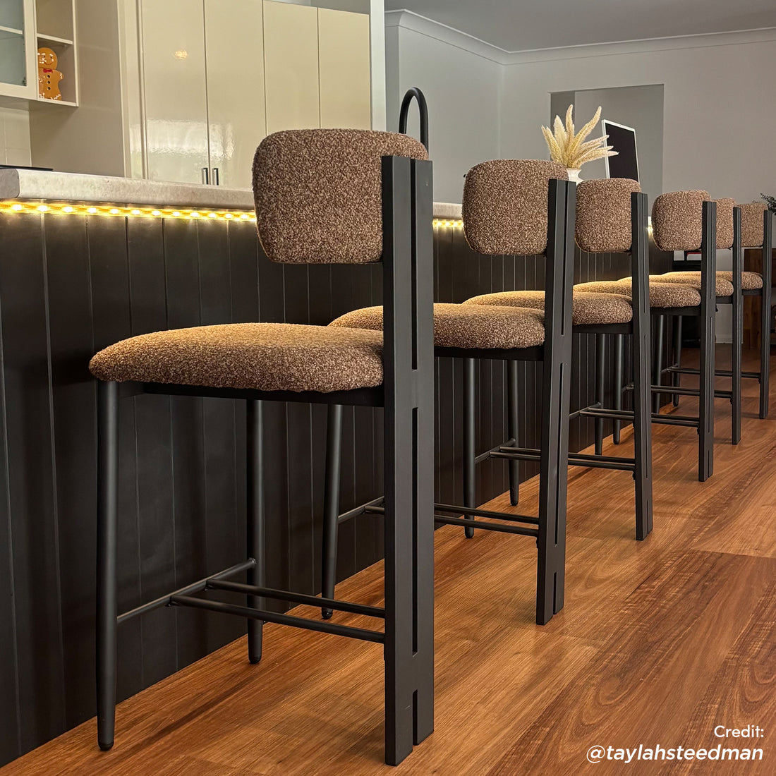 Haleo Curved Boucle Fabric Barstool in Rust Brown with black metal frame, curved backrest and footrest, shown at kitchen