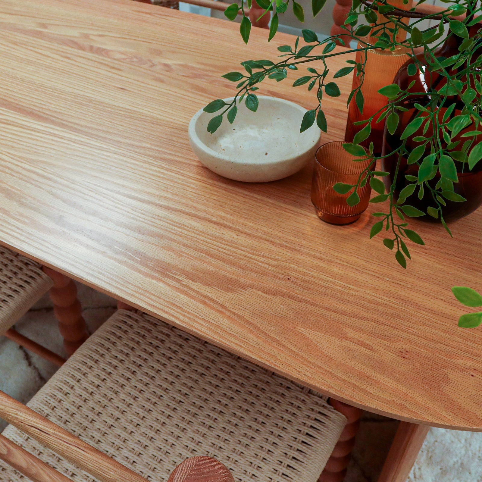Jillian 180cm Solid Oak Oval Dining Table featuring arched legs, showcasing close-up of unique wood grain and sturdy craftsmanship, emphasizing its elegant design and durable solid oak construction.