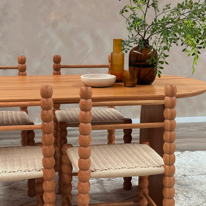Jillian 180cm Solid Oak Oval Dining Table with arched legs on display, emphasizing its unique grain patterns and sturdy construction, suitable for creating an inviting dining space.