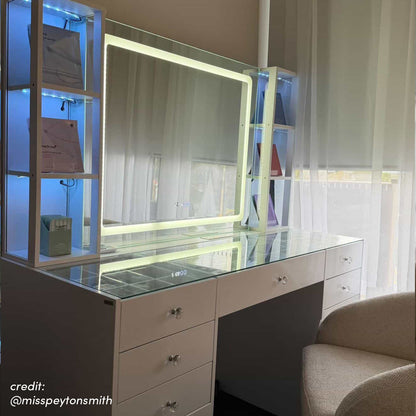 White LED vanity table with illuminated mirror, glass top, storage drawers and side shelving with blue lighting
