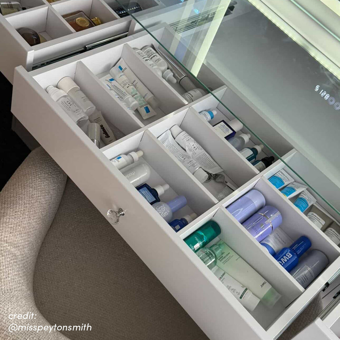 White vanity drawer with LED lighting and organised skincare compartments