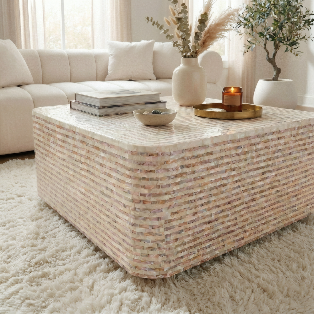 Square mother of pearl coffee table with mocha cream mosaic pattern, rounded edges, styled with books, vase, candle and bowl