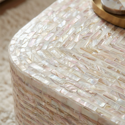 Close-up of mother of pearl mosaic pattern in mocha cream tones on curved coffee table edge