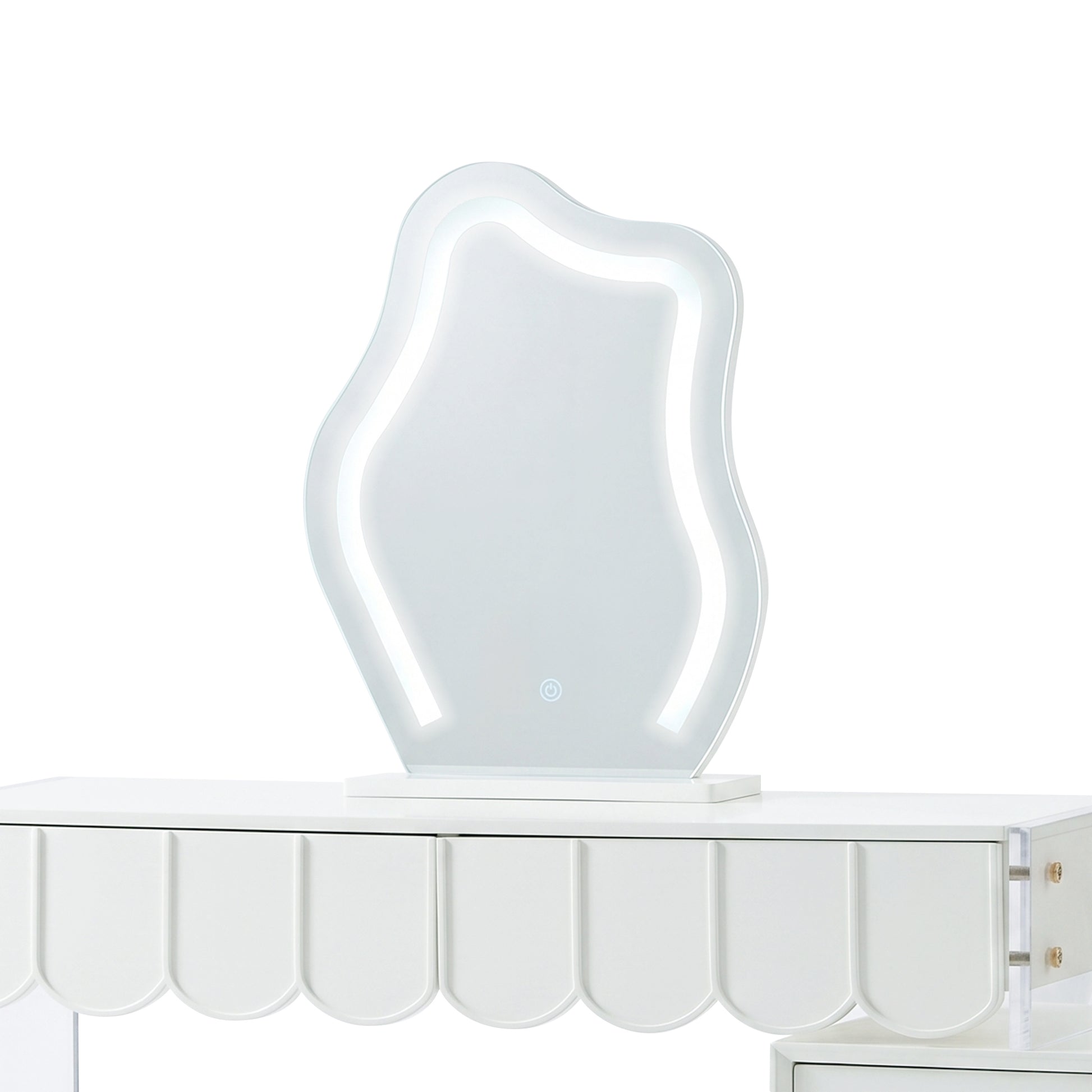 Wavy LED vanity mirror sitting on a white dressing table with a scalloped apron.