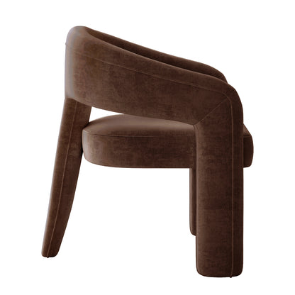 Mariah Velvet Upholstered Accent Chair - Mocha Brown features a modern design with a wrap-around backrest, thick padded seat, and sculptural silhouette, supported by chunky, slightly tapered legs for a contemporary, cozy look.