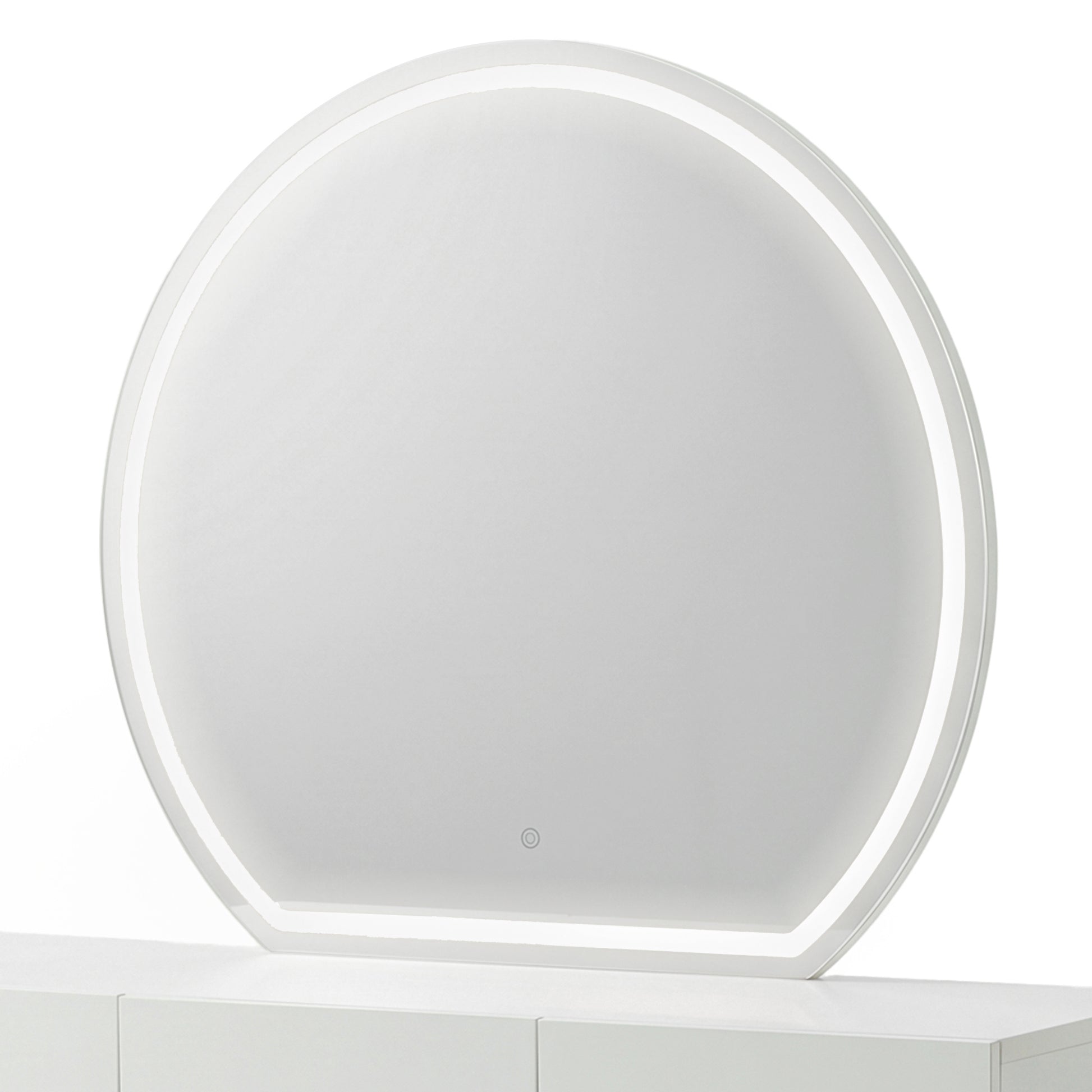 Modern round makeup mirror with an illuminated white frosted border on a white console table.