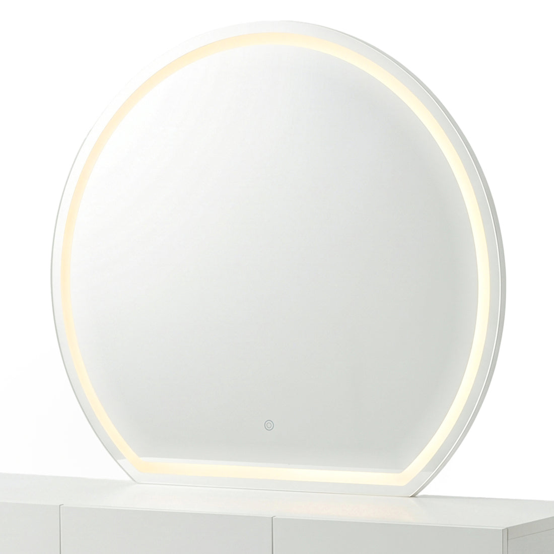 Modern round makeup mirror showing the warm yellow light setting on a white console table.