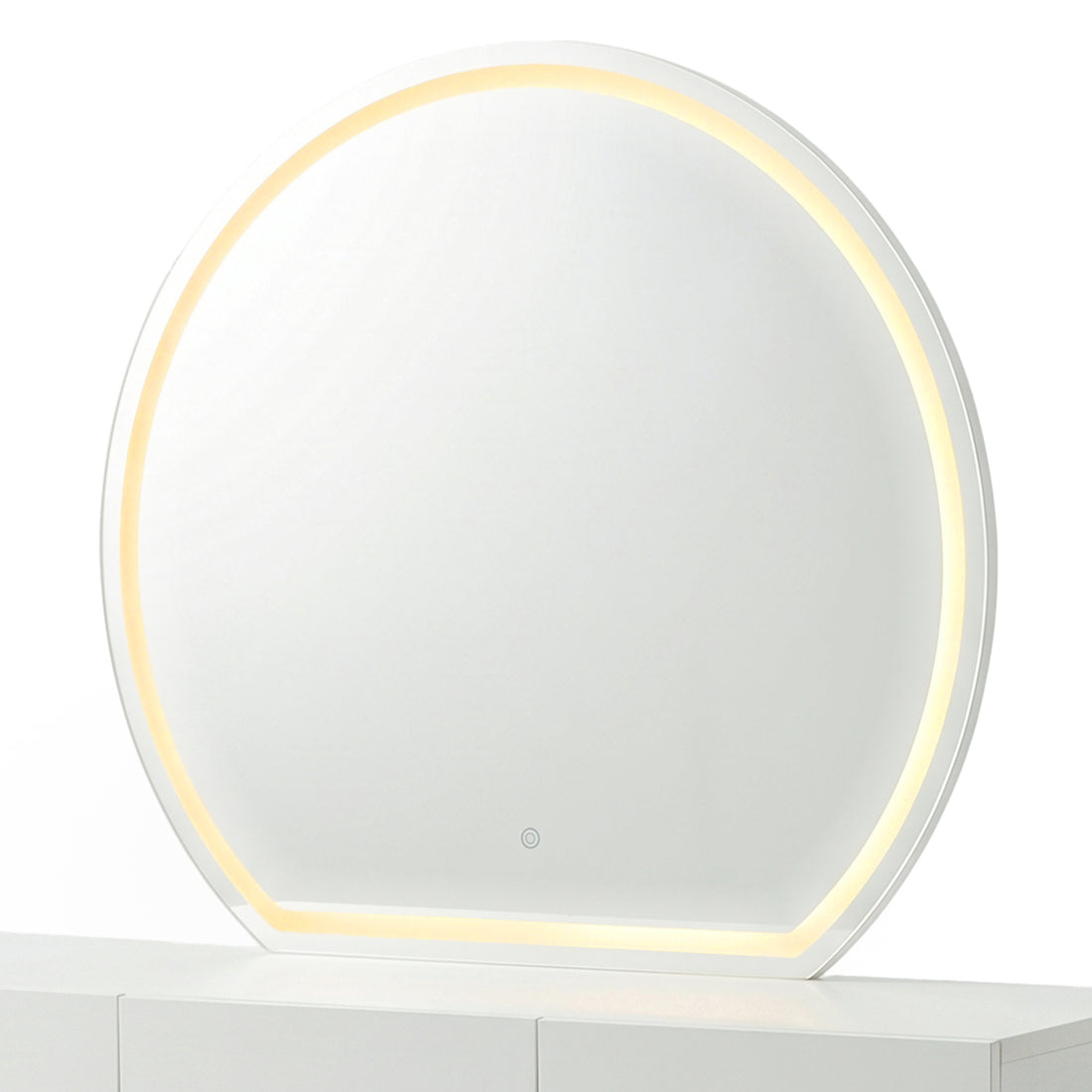 Modern round makeup mirror showing the warm yellow light setting on a white console table.