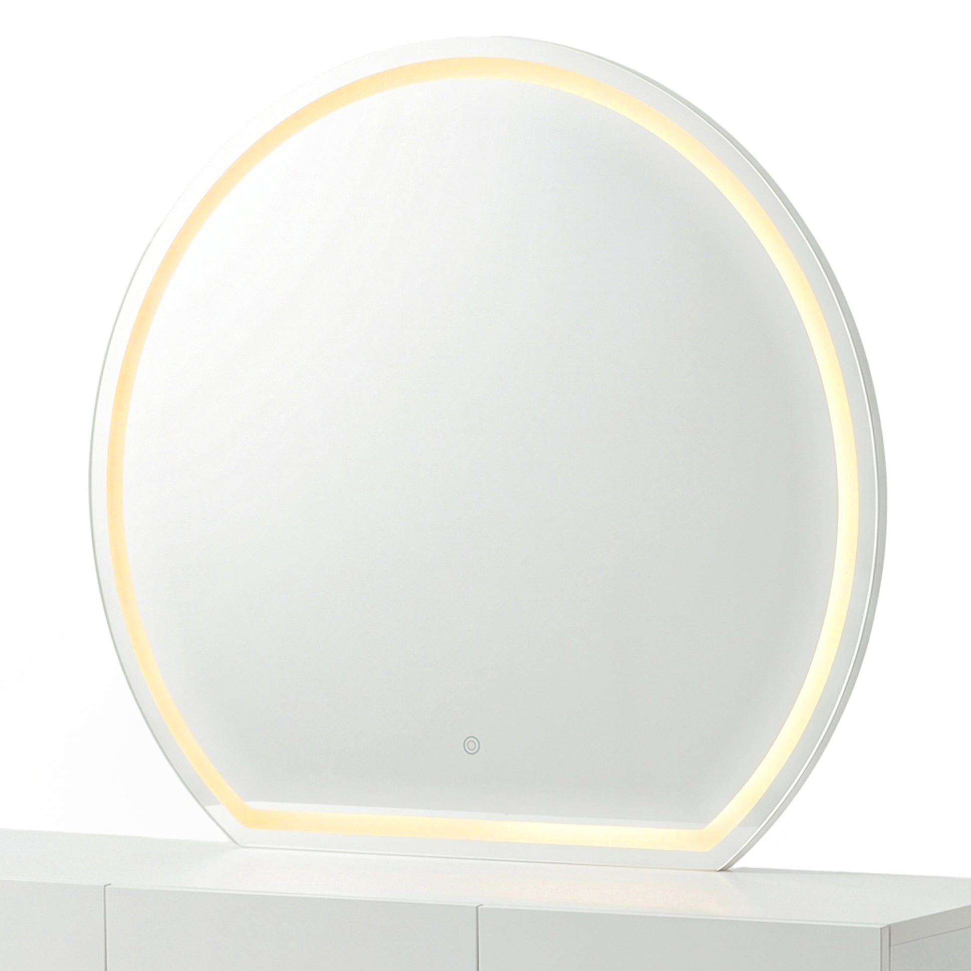 Modern round makeup mirror showing the warm yellow light setting on a white console table.