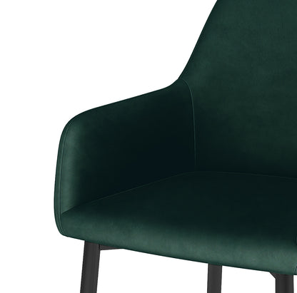Raynie Velvet Dining Chair Set of 2 in Deep Green, featuring a modern design with a softly curved back, integrated armrests, plush velvet upholstery, and slim, dark metal legs for elegant dining room style.