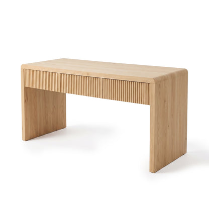 Light wood desk with three drawers and rounded edges on a white background, shown from a slight angle.